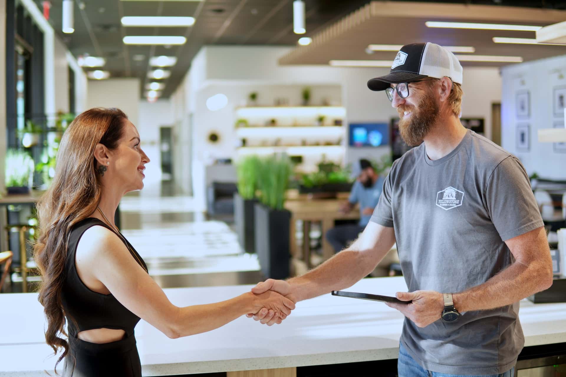 Yellowstone Plumbing customer shaking hands after reviewing service options