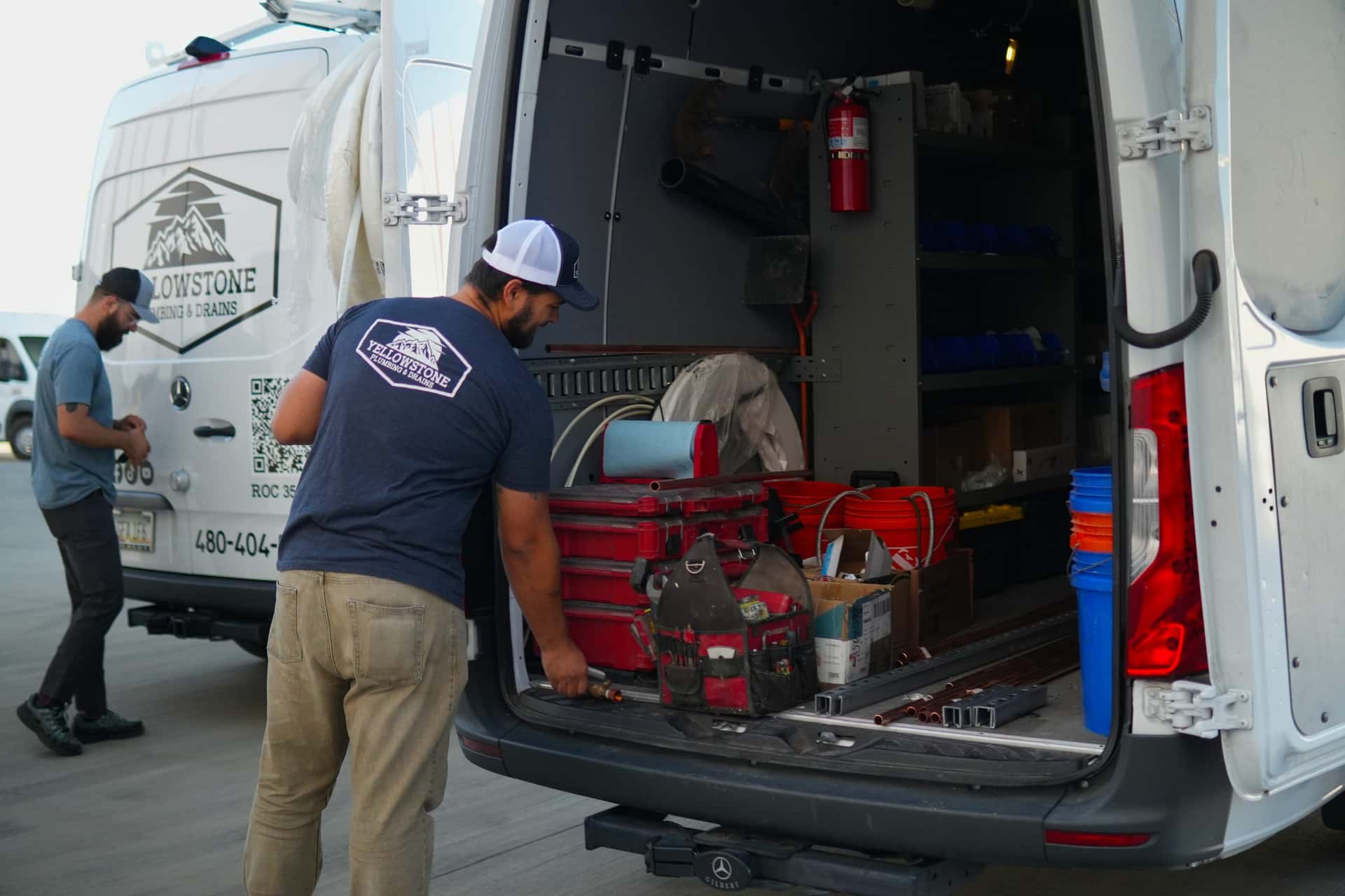 Yellowstone Plumbing & Drains service van parked outside a home